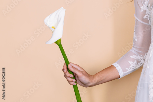 Unrecognizable bride with Zantedeschia flower
