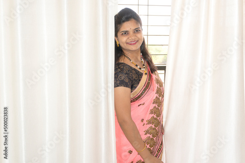Happy young beautiful Indian woman in saree. © Raksha