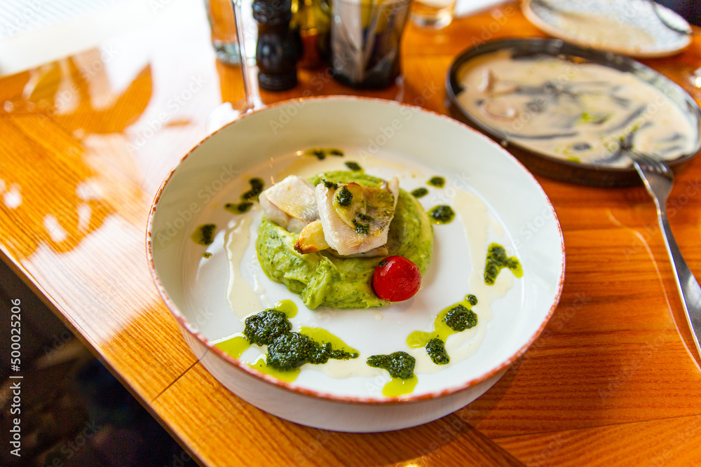 Baked zander fillet with herbs, combined with mashed potatoes with pesto. Garnished with wine sauce Baked zander fillet with herbs, combined with mashed potatoes with pesto. Garnished with wine sauce