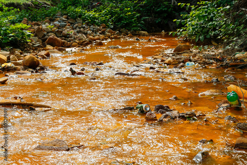 Contaminated river full with gold mining waste residuals in Rosia Montana, Romania photo