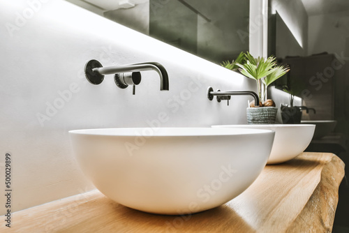 Round washbasins with modern faucets
