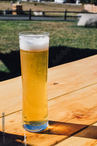 half liter of beer in stange glass photo