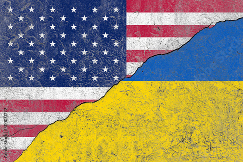 United states and ukraine flag on a cracked old concrete wall