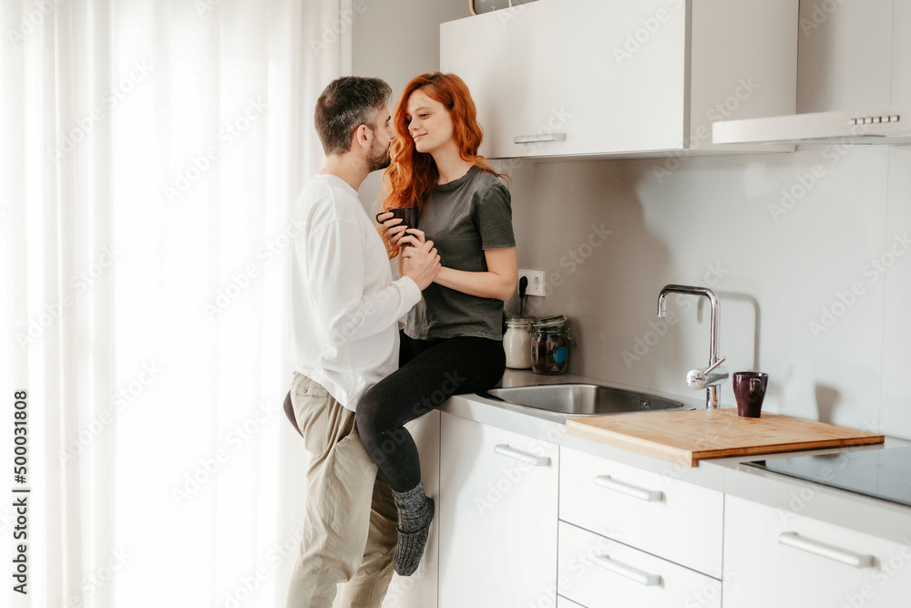 Couple caressing on kitchen counter Couple caressing on kitchen counter