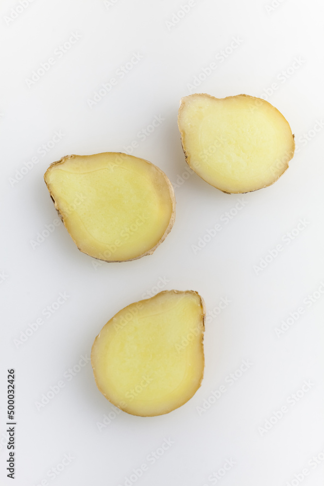 Fresh ginger slice isolated on white background. Top view. Fresh ginger slice isolated on white background. Top view.
