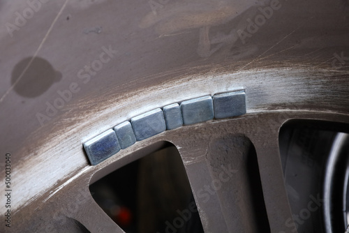 Balancing lead mounted on car wheel photo