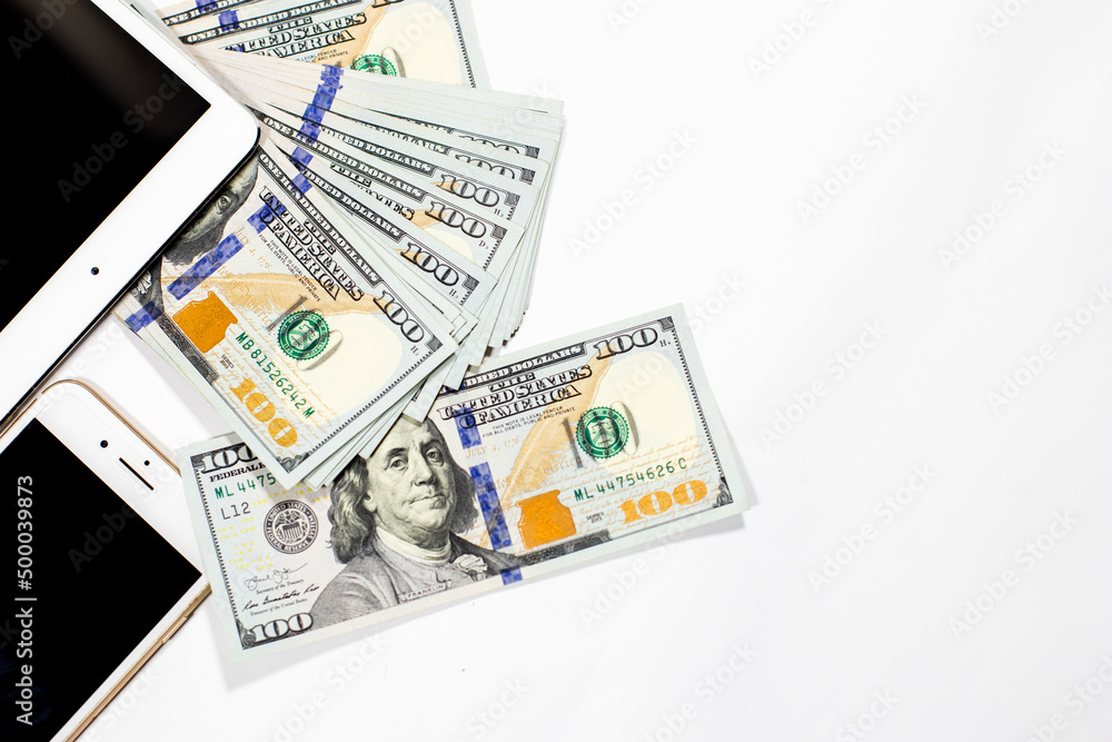money dollars and phone with a tablet on a white background money dollars and phone with a tablet on a white background