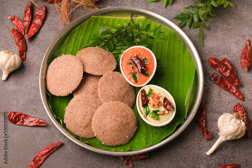 raagi idly served in a banana leaf with chutneys ,south indian famous breakfast idly photo