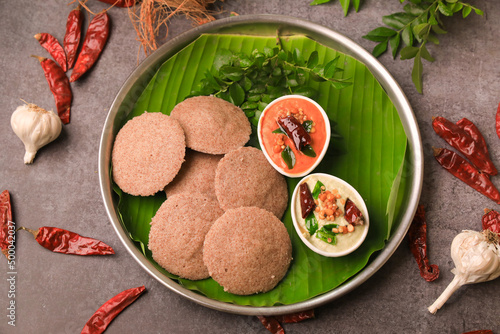 raagi idly served in a banana leaf with chutneys ,south indian famous breakfast idly photo