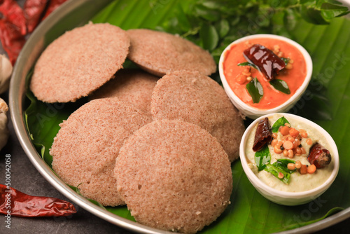 raagi idly served in a banana leaf with chutneys ,south indian famous breakfast idly photo