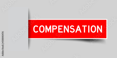 Inserted red color label sticker with word compensation on gray background