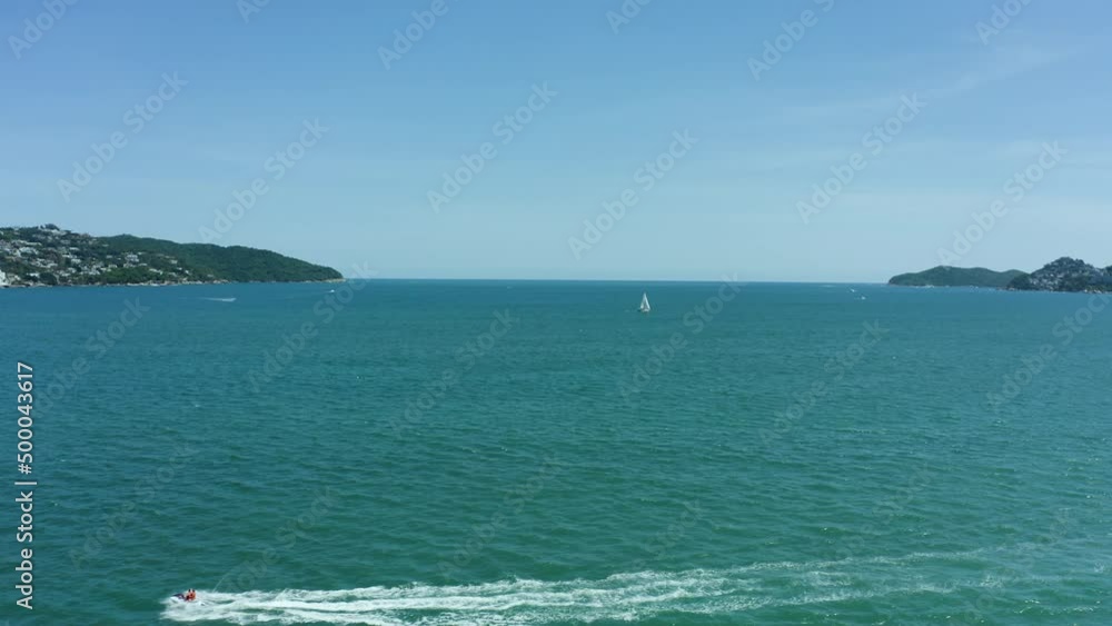 Tourist on Jetski Sea Doo in Tropical Acapulco Bay, Mexico - Aerial Tourist on Jetski Sea Doo in Tropical Acapulco Bay, Mexico - Aerial