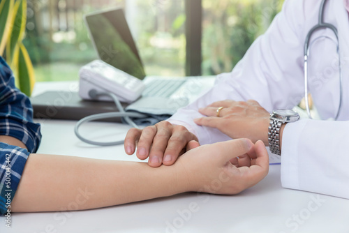 Doctor examining patient pulse by hands. Healthcare and medical service.