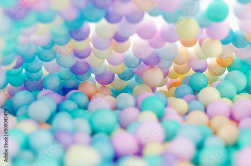 Foam beads of various colors brightly colored abstract background.
