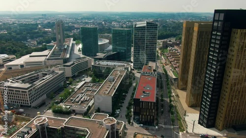 Aerial view of Downtown Kirchberg quarter of Luxembourg City. Court of Justice and Administrative Offices of European Union. Urban Cityscape with Skyscrapers. 4K drone panoramic establishing shot photo