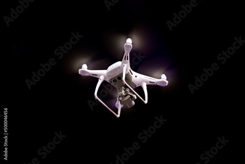 Drone is flying against isolated black background