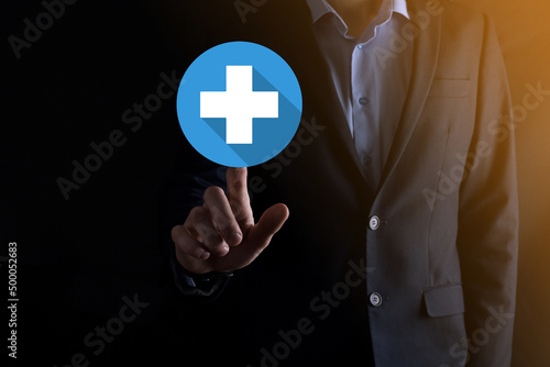 Businessman hold plus icon, man hold in hand offer positive thing such as profit, benefits, development, CSR represented by plus sign.The hand shows the plus sign.flat icons with long shadows