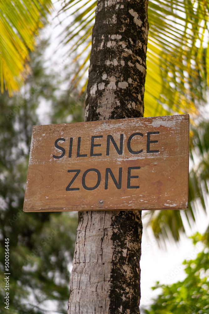 Sign of silent zones on a palm tree at a resort in the Maldives