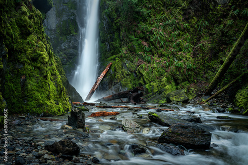 View of a waterfall and water stream with plants in Goldstream Provincial Park, Victoria, BC Canada photo