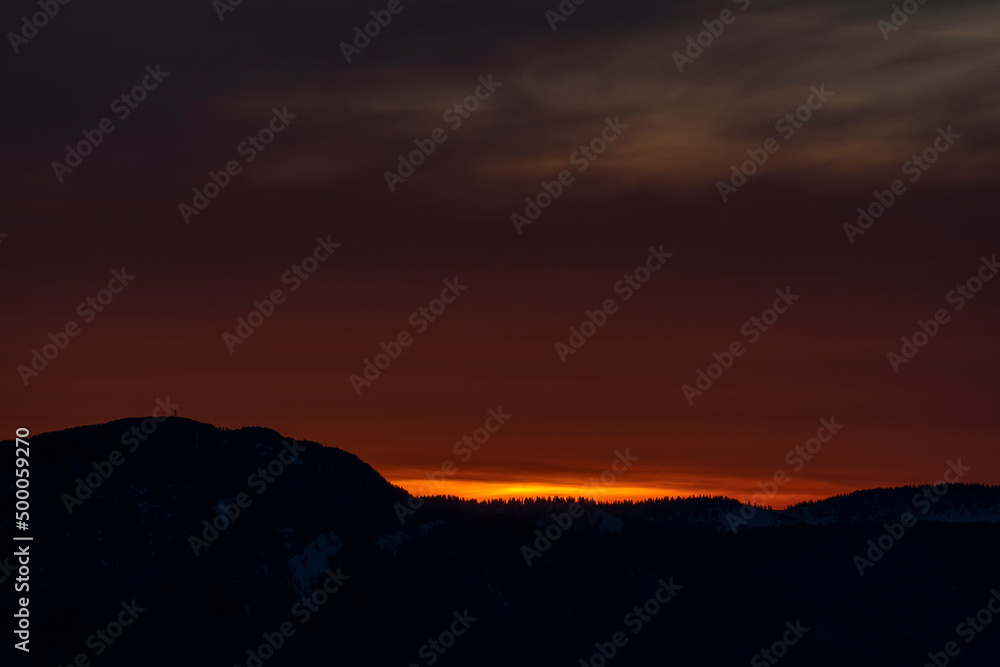 Dark red sunset and mountain silhouette
