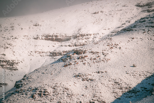 Beautiful landscape view of cliffs covered with snow against a gray sky in Matroosberg, South Africa photo