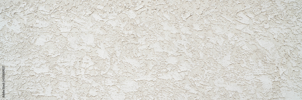 rough stucco texture background on an exterior building wall, panoramic web banner