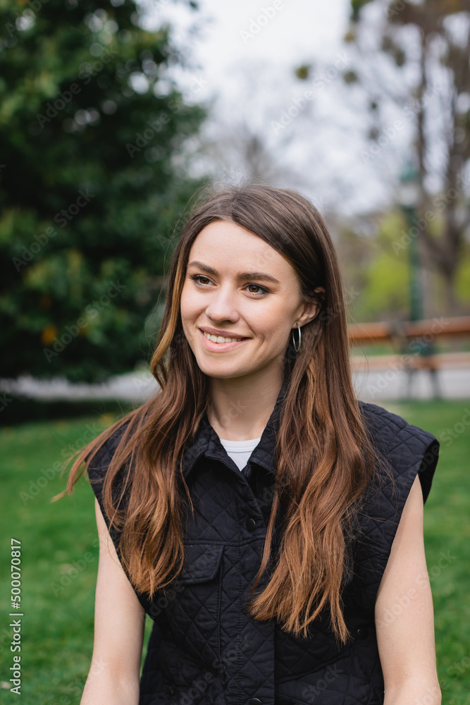 portrait of young happy woman in sleeveless jacket. portrait of young happy woman in sleeveless jacket.