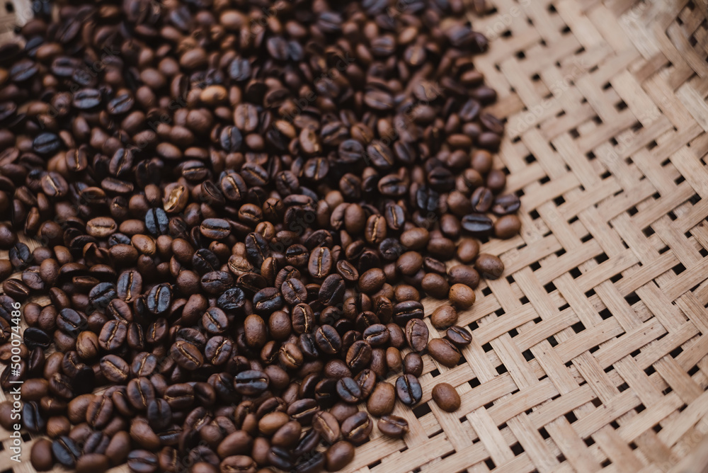 Fototapeta premium Roasted coffee beans are piled up in Thai wicker baskets.
