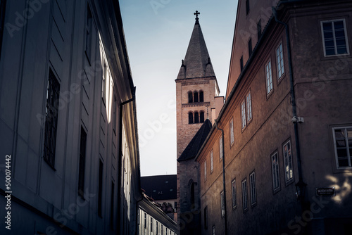 Narrow street in Prague castle with tower of St. Georges Basilica on background. Prague, Czech Republic photo