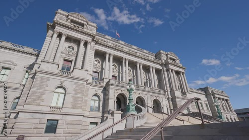 The Library of Congress - Thomas Jefferson Building located at 101 Independence Ave SE in Washington D.C.'s Capitol Hill neighborhood. Static, low-angle wide shot with blue sky and clouds. No people. photo