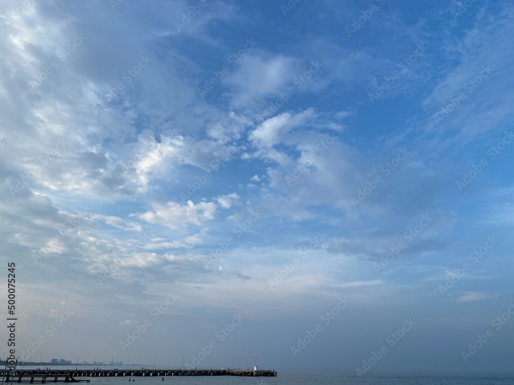 Copy space on the beautiful blue sky over the sea.  Fresh air.  Good weather.