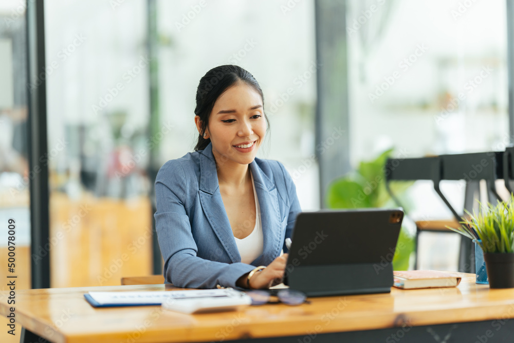 Portrait of Asian young female working on laptop at office, business financial and investment concept. Portrait of Asian young female working on laptop at office, business financial and investment concept.