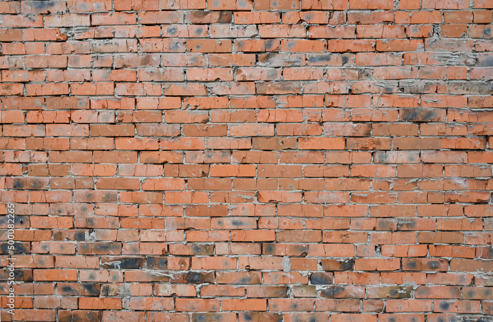 Naklejka premium Red brick wall. brick background