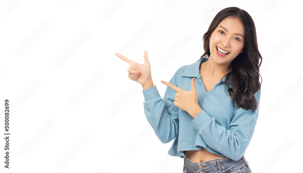 Beautiful young Asian woman pointing up to copy space and looking at camera with smile face and happy Pretty girl act like a satisfied product, use for advertising with isolated on white background Beautiful young Asian woman pointing up to copy space and looking at camera with smile face and happy Pretty girl act like a satisfied product, use for advertising with isolated on white background