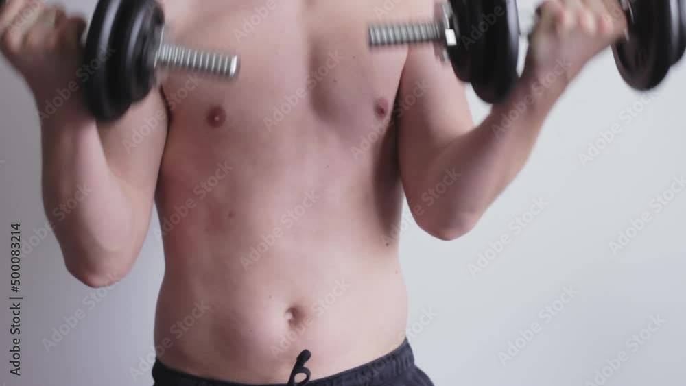 Man exercising biceps curls both arms, shirtless adult man workout exercise, static medium closeup Man exercising biceps curls both arms, shirtless adult man workout exercise, static medium closeup
