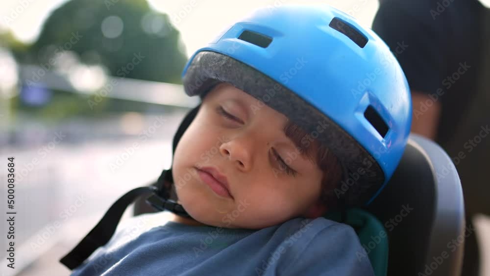Little boy sleeping wearing helmet child asleep with bicycle helmet Little boy sleeping wearing helmet child asleep with bicycle helmet