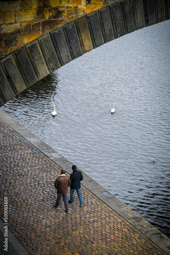 people walking along the river