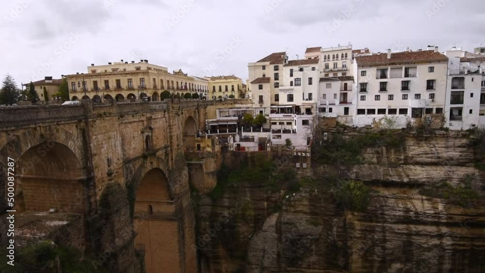 wide angle view over Puente Nuevo and El Tajo Gorge, and white buildings of Ronda, Andalucia, Spain wide angle view over Puente Nuevo and El Tajo Gorge, and white buildings of Ronda, Andalucia, Spain