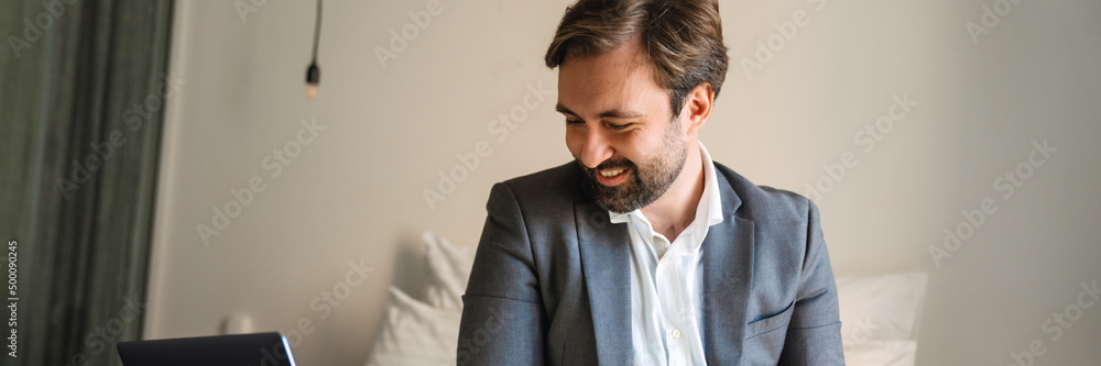 Obraz premium Smiling mid aged bearded man in formal wear
