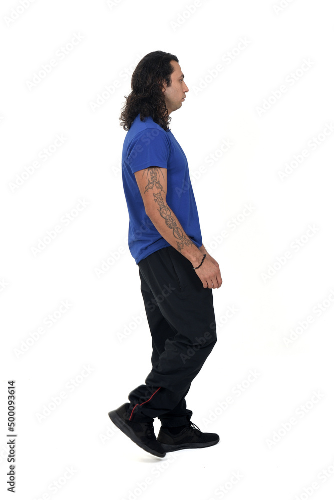 side view of a man with sportswear walking with tattoo on arms on white background side view of a man with sportswear walking with tattoo on arms on white background