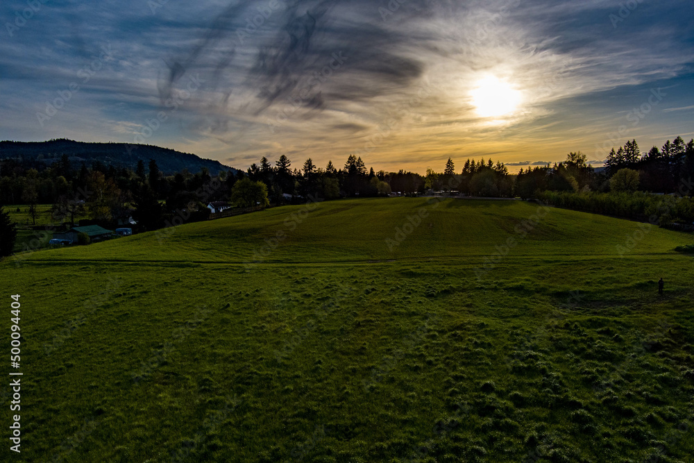 Fototapeta premium Sunset over a peaceful meadow