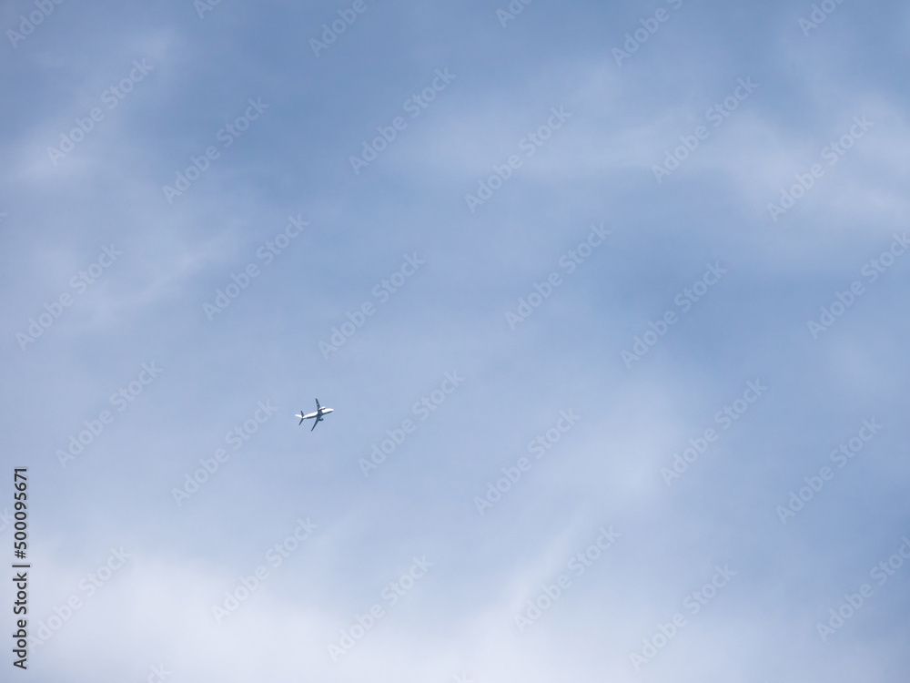 Airplane is flying in clear blue sky. Aircraft in flight in good weather. Minimalism. Airplane is flying in clear blue sky. Aircraft in flight in good weather. Minimalism.