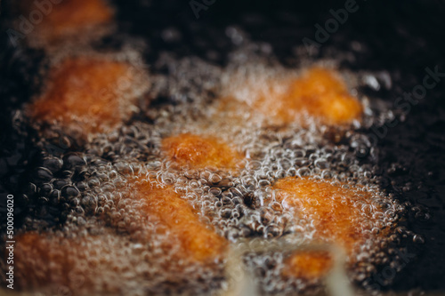 Close up image of cooking chicken nugget tempura in deep fry