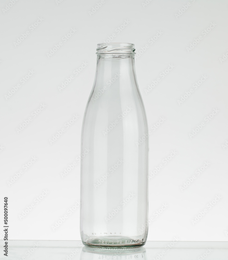 Empty glass bottle without cap. Bottle for milk and water isolated on white background. Empty glass bottle without cap. Bottle for milk and water isolated on white background.