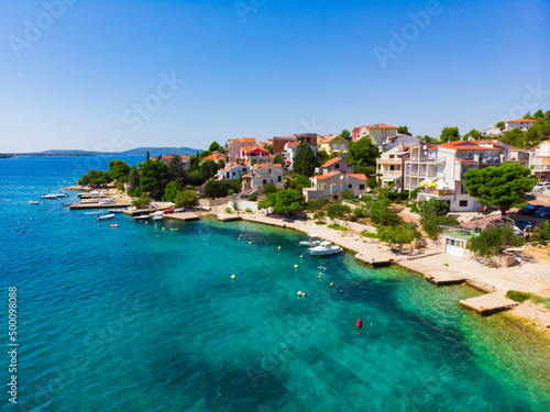 Croatia. Summer. Sunny day. Coast of the Adriatic Sea. Small town by the sea. Holiday season. Popular tourist spot. Drone. Aerial view