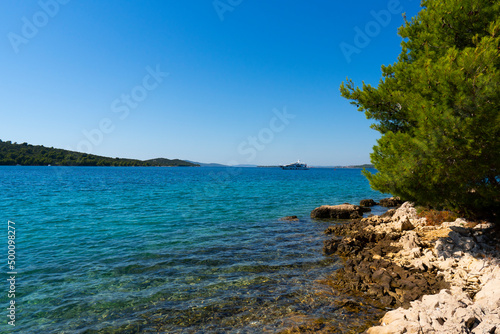 Croatia. Summer. Sunny day. Rocky shore of the Adriatic Sea. Tourist season. Popular holiday destination