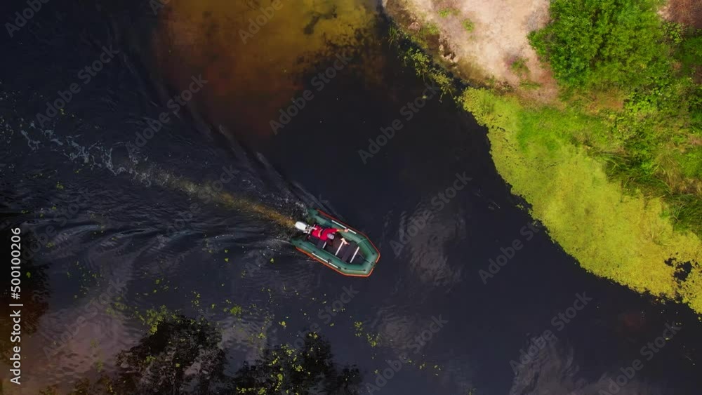 Top View Fisherman Moves On The Orel River On An Inflatable Motor Boat Top View Fisherman Moves On The Orel River On An Inflatable Motor Boat
