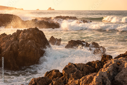 Photography Rough sea waves hit the rocks at the famous surfing beach of Canallave at sunset