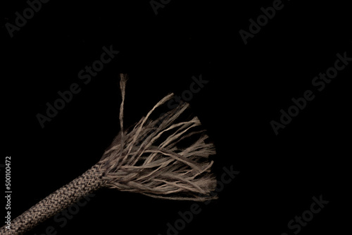 Slika na platnu Close up macro shot of a frayed shoe lace texture isolated on black with copy sp