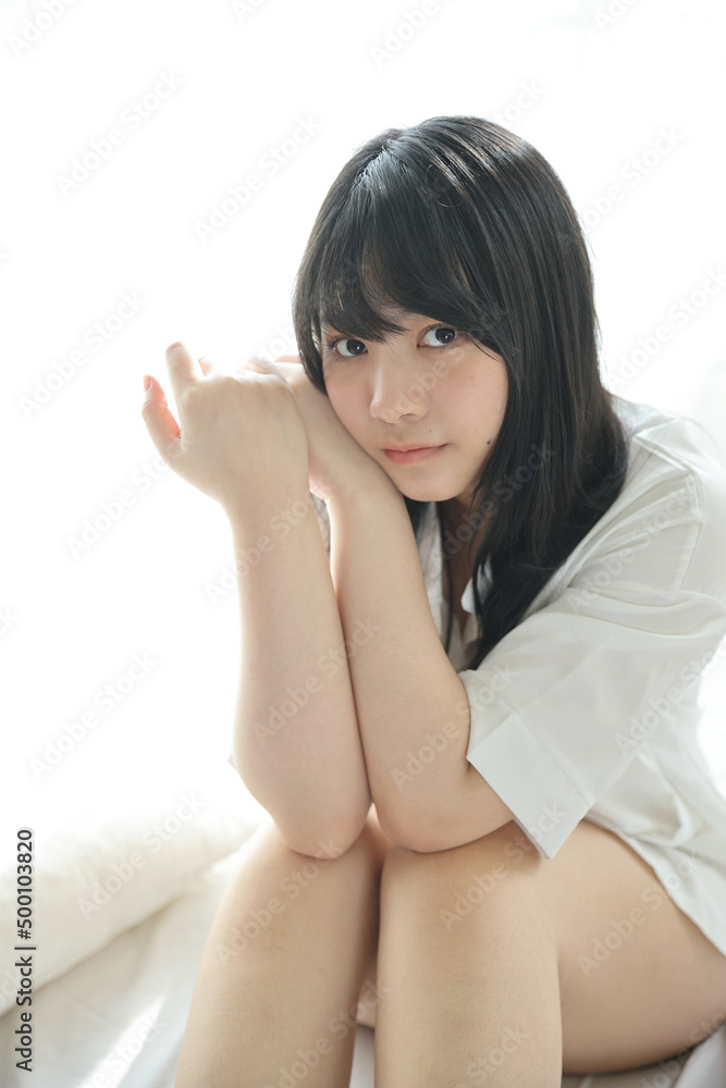 Beautiful young woman waking up in the morning at white bedroom Beautiful young woman waking up in the morning at white bedroom